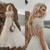 Aankomst Hollow Back Lace Trouwjurken Een lijn Sweep Train Bridal Toga Tulle Boheemse strandjurken