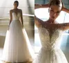 Lyx A Linje Pearl Bröllopsklänning Sexig Illusion Långärmad O-Neck Glitter Tulle Bridal Gown Sweep Train Bride Robe de Marie