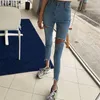 SHIJIA Herbst Frauen Denim Jeans Quaste Dünne Blaue Zerrissene Löcher Chic Böden Hohe Taille Stretch Unregelmäßige Jeans Weibliche 210302