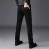 SHAN BAO hiver marque ajusté droite Stretch pur noir jean Style classique hommes mode polaire épais chaud mince 211108