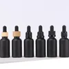 Nieuwste matte zwarte glazen druppelaar flessen 30ml etherische olie cosmetische containers met bamboe zilver gouden caps