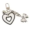 Korean Love Black White Bowknot Keychain Pendant Söt Bell Kedja Hängsmycke Kvinnor Bilväska Dekor Cartoon Key Ring Nyårsgåva