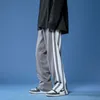 Luźne spodnie Moda męska Dorywczo Oversize Zipper Spodnie Kobieta Stripe KPOP Mężczyzna Streetwear Odzież