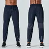 lu yoga vêtements hommes nouveau automne et hiver séchage rapide couleur unie sports et loisirs course pantalon de fitness ample avec poches lu-C621