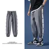 Pantaloni casual autunnali Uomo Hip Hop Streetwear con due file di bottoni Pantaloni oversize alla moda da uomo Pantaloni da jogging da uomo