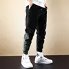 Jesień Ly Designer Fashion Men Jeans łączone naszywki Casual sztruksowe spodnie Cargo kombinezony Streetwear hiphopowe spodnie do biegania