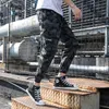 メンズパンツ男性ストリートウェア迷彩貨物ヒップホップカジュアルバギー戦術ズボンポケットコットンファッションスウェットパンツ5xl