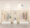 衣料品店の陳列ラックの商業家具の床のタイプの女性の布の店のサイドの吊り台ヨーロッパのゴールドの組み合わせ服ハンガー