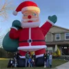 Juegos al aire libre gigantes Decoración divertida Inflable Santa Claus Air Padre navideño con bolso en la mano para la fiesta del festival