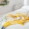 gele gebreide deken