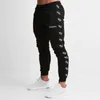 Мужские Joggers Повседневная Брюки Фитнес Мужчины Спортивная одежда Косцейстраз Нижние днища Человек Тощие Дужные Успонники Брюки Мужские Тренажеры Джоггер Трек Брюки Q190521