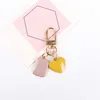 Sevimli Damlama Yağı Yuvarlak Kalp Anahtarlık Kulaklık Kapak Koruyucu Moda Anahtarlık Kadın Çantası Araba Tutucu Takı Hediye Küçük Beşik G1019