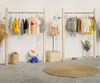 Magasin de vêtements pour enfants présentoirs de toit créatifs meubles commerciaux en acier inoxydable en bois massif mur suspendu combinaison rack double couche étagère