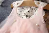 Robe de fille coréenne Xiaoqingxin en gros de style européen et américain en dentelle maille broche perle col châle gilet sans manches pour enfants en jupe de princesse