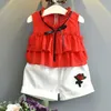 女の子セット夏の赤ん坊の服のノースリーブの弓Tシャツ+チェック柄のボタンショートパンツ2ピースの子供210515