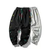 2021 Men Hip Hop Sweatpants Calças Laterais Botões Elásticos Cintura Elástica Estilo Solto Calças Y0927