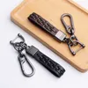 3 Colors Metal Stirrup Leather Keychain Men Hand Woven Car Styling Keyring Holder Charm Accessories Auto Decorative Jewelry Gift G1019