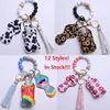 12 färger 4st / set mode keychain set med hand sanitizer flaska och påse pärlor armband band läppstift hållare nyckelringar för kvinna män säkerhet nyckelring armband