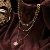 Famshinボヘミア多層女性の真珠のコインペンダントネックレスビンテージゴールドカラーロングネックレスファッションジュエリー