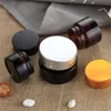 5g 10g 15g 20g 30g 50g Frascos de vidrio marrón ámbar Botella de crema facial Envase cosmético con revestimiento interior y tapas negras plateadas doradas