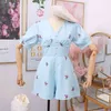 Djup V-Neck Beach Playsuits Kvinnor Vintage Blomstryck Högt midja Wide-Legged Shorts Byxor Knapp Slim Holiday Jumpsuits 210430