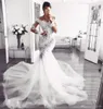 Glamorös afrikansk sexig bröllopsklänning 2022 Lace Mermaid Appliques Bridal Gown Sheer Neck Plus Size Bride Robes de Mariée Långärmade ärmar