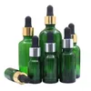 Garrafa de óleo essencial verde Matéria Borracha preta Borracha de ouro brilhante Anel de prata vazio Embalagem de embalagem de embalagem de embalagem de vidro vials 5ml 10ml15ml 20ml 30ml 50ml 100ml