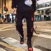 الرجال السراويل 2021 اليابانية المتناثرة الأزياء الشارع الشهير الرجال شرائط الحريم ركض البضائع الهيب هوب عارضة الذكور جيوب الملابس