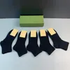 Chaussettes en coton avec lettres de couleur unie pour femmes et hommes, chaussettes respirantes décontractées avec timbre, noir et blanc, bonneterie à la mode de haute qualité