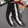 Męskie Legginsy Spodnie Deskorolka Deskorolka Spodnie dresowe Mężczyźni Fall Moda Sznurek Sport Streetwear Hip Hop Harem Pant Spodnie Y0927