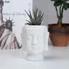 white ceramic buddha