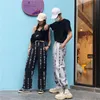 Tendance Hip Hop Harajuku pantalon mode caractères chinois imprimé ample jambe large femmes taille élastique décontracté rétro pantalon femmes Capris