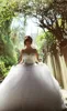 Bröllopsklänningar Real Image Luxury Crystal Bridal Gowns med pärlor Sheer Illusion Crew Neck Långärmad Plus Size Lace-up Corset Back