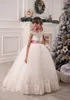 2015 Tulle Flower Girl Dresses Sheer Beaded Appliques Fluffy Christmas Ball Gowns for Wedding Keyhole Lace-up Bows Lovely Custom Made Dress