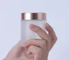 スキンケアの曇りの透明なガラスの瓶の瓶の化粧品のフェイスクリーム容器が付いているローズゴールドのふたが付いている50g 15 g 30 gの50 gの100 g SN5962