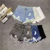 Coréia Moda Verão Mulheres Cintura Alta Botão Sexy Buraco Rippe Jean Shorts Algodão Demin solto Plus Size D212 210512