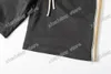 21SS Erkekler Baskılı T Shirt Polos Tasarımcı Yansıtıcı Bant Paris Giysi Kısa Kollu Erkek Gömlek Etiketi Gevşek Stil Siyah