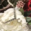 レディースデザイナーネックレスパールネックレス女性ダイヤモンド真鍮グラスクリスタルボウバタフライシンプルラグジュアリーエレガントな雰囲気