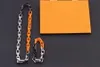 Europa amerika mode ketting armband mannen vrouwen zilver zwart oranje-kleur metalen gegraveerde v letter bloem patroon dikke ketting sieraden sets M68241 M69449