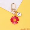 Söt liten daisy blomma mode koreanska nyckelring för kvinnor flicka alfabetet brev nyckelring hörlurar väska hänger