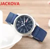 Fábrica Relojes a prueba de agua Famoso diseñador clásico Estilo de pareja Cronómetro unisex Moda Tela de nylon Calendario de cuarzo Hombres Mujeres Reloj