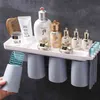 Porte-brosse à dents inversé à adsorption magnétique avec tasse de montage mural maquillage dentifrice accessoires de rangement de salle de bain ensemble 210423