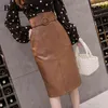 Taille haute PU Jupe Femme Genou Longueur Slim Ceinture Irrégulière Luxe Vintage Automne Hiver Cuir Plus Taille Faldas 210506