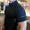 Noir hommes T-shirt à fermeture éclair Gym course formation Fitness musculation Sport décontracté coton à manches courtes hommes hauts t-shirts