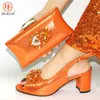 orange color high heeled buty