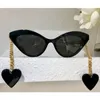 Gafas de sol para mujer G0978S Moda clásica colgante en forma de corazón patillas de metal aretes tipo ojo de gato gafas de sol con marco con patrón de cebra 8915656