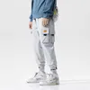 Streetwear Hip Hop Cargo Pants Uomo Donna Tasche Pantaloni da jogging stile coreano Pantaloni casual Harem Uomo Dropshipping X0723