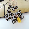 2020 Leopard PU Läder Dog Tassel Nyckelring på väska Trinket Mode Guld Charm Bil Keychain Smycken Kvinnor Väska Tillbehör Present