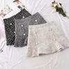 Outono nova saia coreana feminina Hight cintura Mini -saia sólida elegante ladies botão lótus folha de lã Wrap saias femininas 2103331