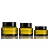 la crème en verre ambre verte de 15g 30g 50g cogne l'emballage cosmétique avec les chapeaux en plastique noirs de couvercle DH0032